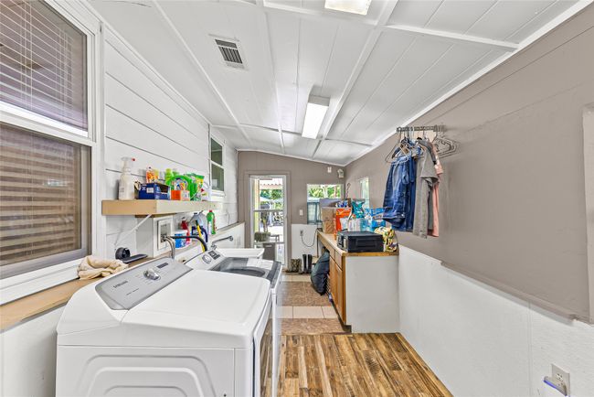Laundry area with washer and dryer and light wood-type flooring | Image 21