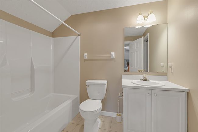 View of the full bath located in the upper level bedroom. Walk in closet to the right of the photo. | Image 17