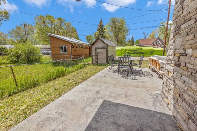 Fenced backyard with outdoor dining space and a patio | Image 34