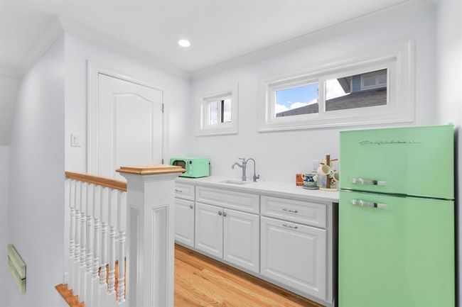 Enjoy the convenience of an upstairs coffee bar, complete with a sink and refrigerator. | Image 29