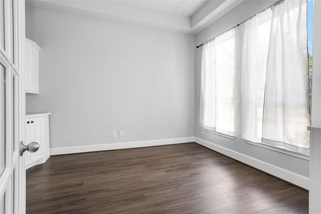 Bright and spacious study with abundant built-in storage, perfect for productivity. | Image 4
