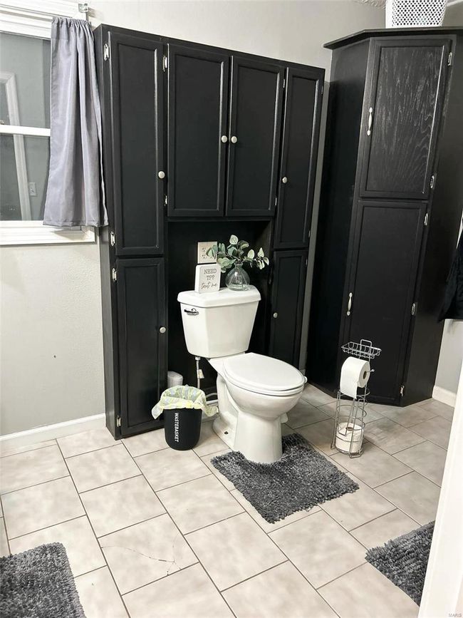 Bathroom featuring tile patterned flooring and toilet | Image 14
