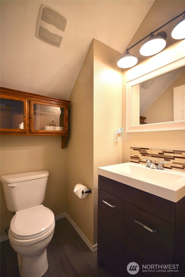 1/2 bath with laminate floors and vanity. | Image 20