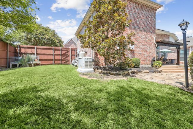 View of side yard with a whole home generator | Image 36