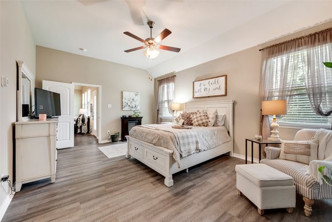 Bedroom with multiple windows, light wood-style floors, and a ceiling fan | Image 29