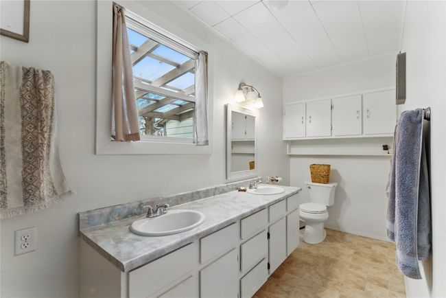 Full bathroom featuring toilet, crown molding, a sink, and double vanity | Image 17