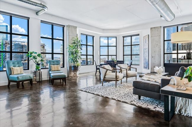 View from living area out to the city and hill country views from the wall to wall and bay windows. | Image 13