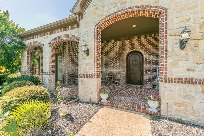 Doorway to property with brick siding and stone siding | Image 8