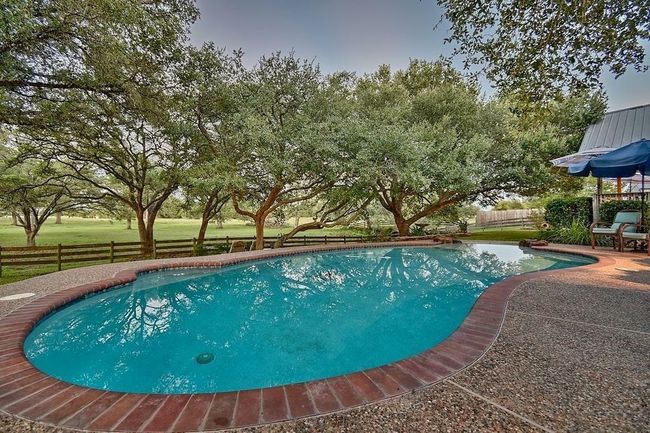 Sparkling pool with post card views. There is a finished walk way that leads to the mud/powder room. No wet feet tracking through the house. | Image 20