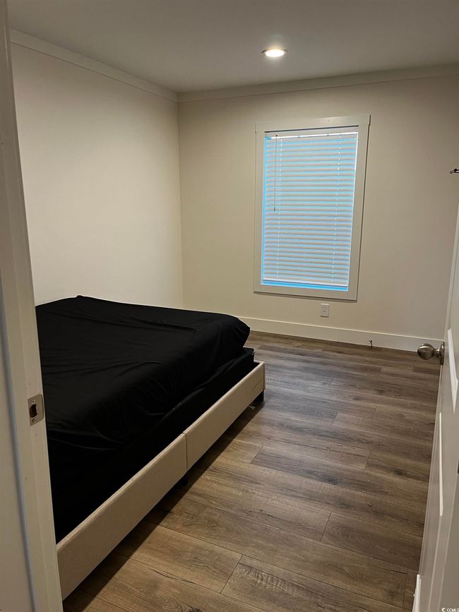 Bedroom featuring wood finished floors, recessed lighting, and ornamental molding | Image 11