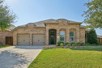 View of front of home with a garage and a front lawn | Image 1