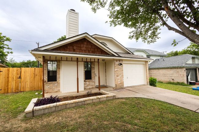 View of front of house with a garage, concrete driveway, brick siding, a porch, and a chimney | Image 6