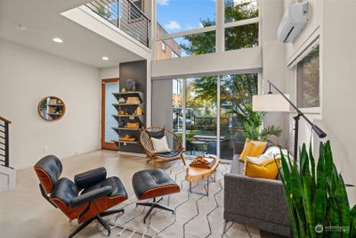 Light & bright living room features radiant heat floors. | Image 3