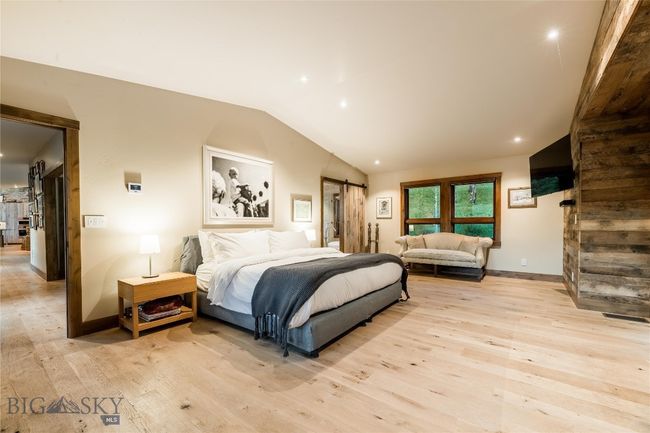 The main level primary suite is situated in a private wing of the home. | Image 28