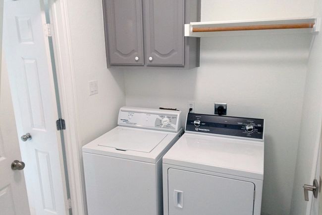 Washroom with cabinet space and washing machine and dryer | Image 35