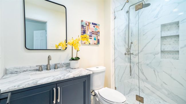 Bathroom featuring vanity, a marble finish shower, and toilet | Image 25