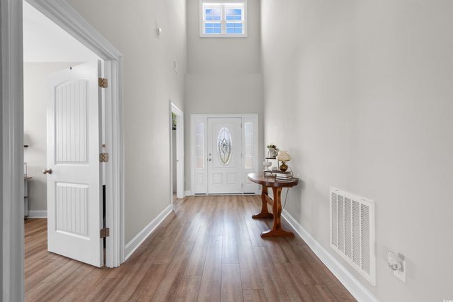 Foyer featuring wood finished floors and a towering ceiling | Image 15