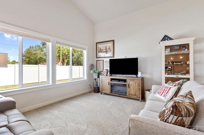 Living area featuring light carpet and high vaulted ceiling | Image 12