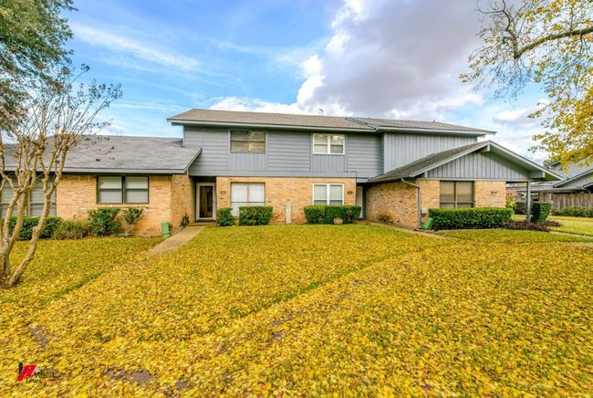 View of front of house with brick siding and a front lawn | Image 4