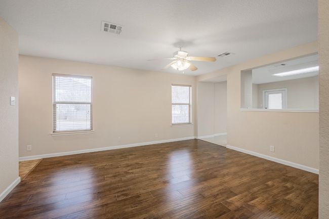 Spare room with a ceiling fan and wood finished floors | Image 10