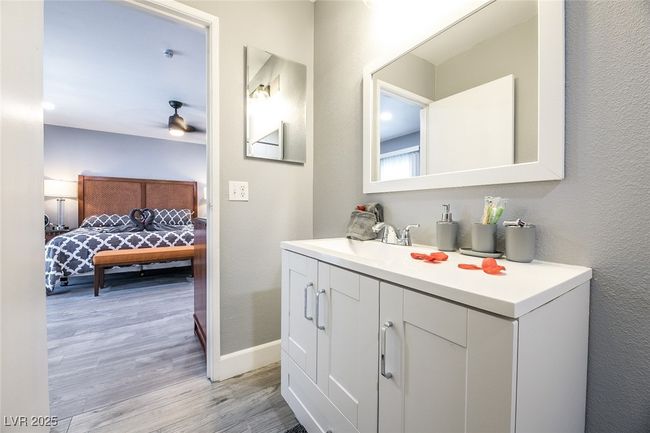 Bathroom with wood finished floors, ensuite bathroom, baseboards, vanity, and ceiling fan | Image 47