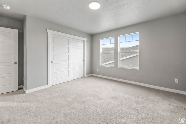 Unfurnished bedroom with baseboards, carpet flooring, and a closet | Image 27