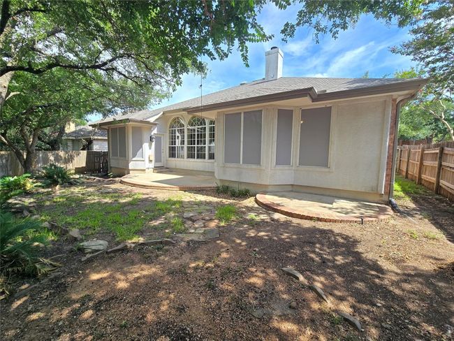 Rear view of property with a chimney, a shingled roof, and a patio area | Image 24