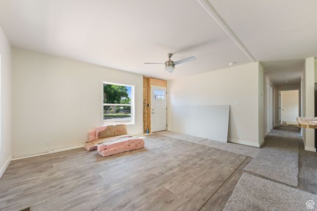 Unfurnished room with a ceiling fan, wood finished floors, and baseboards | Image 8