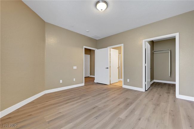 Master bedroom featuring baseboards, and a spacious closet | Image 16