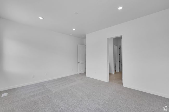 Empty room with light carpet, recessed lighting, and baseboards | Image 13