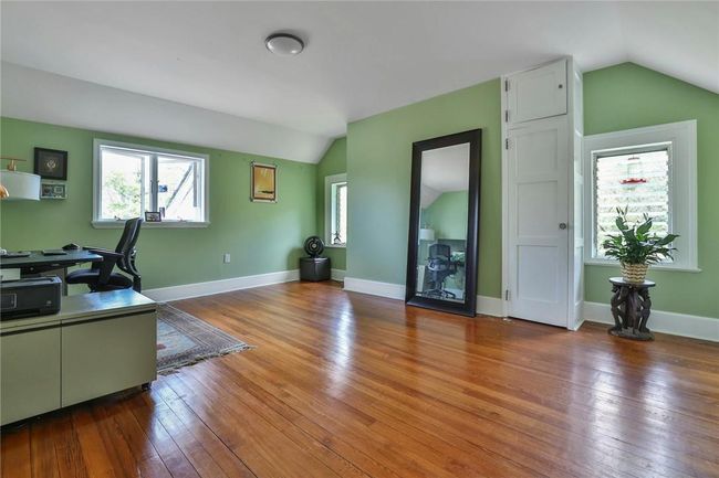 Third floor office / bedroom with vaulted ceiling, hardwood floors and a walk-in closet | Image 33