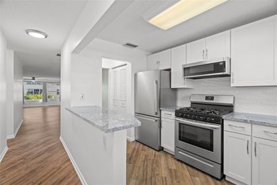 As you enter your condo, you step into a foyer that looks towards the kitchen. | Image 3