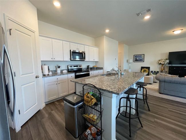 Gather around the island to share your day, complete homework or meal prep. | Image 14