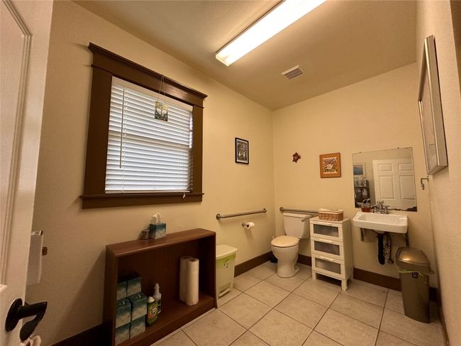 Bathroom featuring toilet and tile patterned floors | Image 17