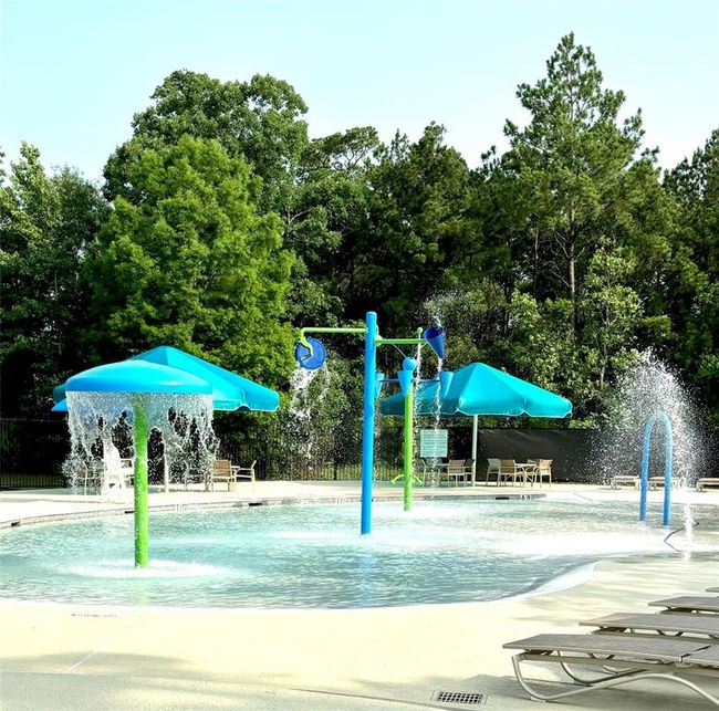 Fun for all ages—this splash pad in The Falls at Imperial Oaks features interactive water elements and shaded seating, making it a perfect spot for cooling off and enjoying sunny Texas days. | Image 43
