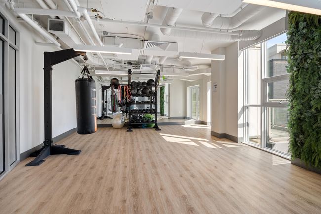 Exercise room featuring visible vents, a wealth of natural light, wood finished floors, and baseboards | Image 21