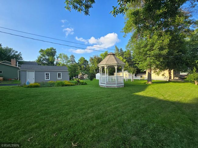 Lush green grass covers the level lot adding to the curb appeal while allowing for many more possibilities of the yard. | Image 22
