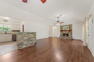 Welcome to 333 Ridgewood! The propane fireplace features stacked stone and a wood beam mantle. A perfect spot to cozy up to for the last little it of winter. | Image 2