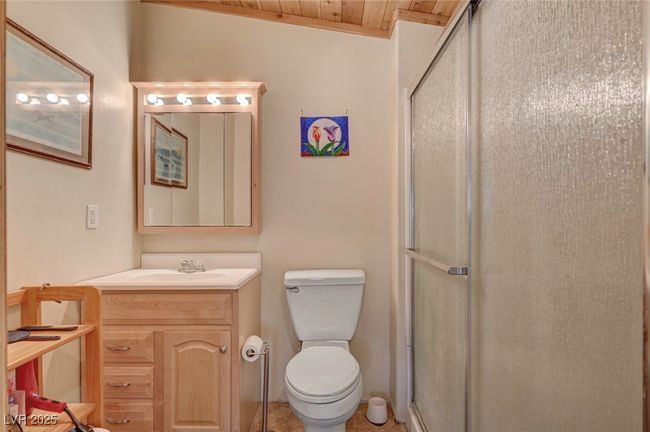 Full bath with a stall shower, vanity, toilet, and wooden ceiling | Image 52
