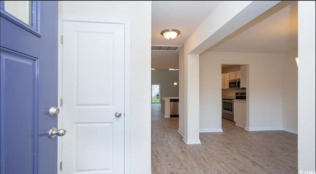 Entryway featuring visible vents, light wood-type flooring, and baseboards | Image 4