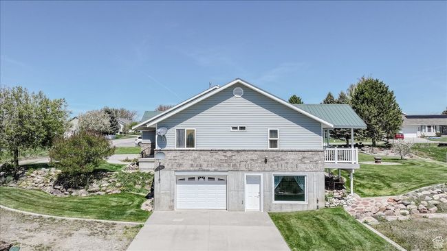 View of home's exterior with a garage, a yard, and driveway | Image 8