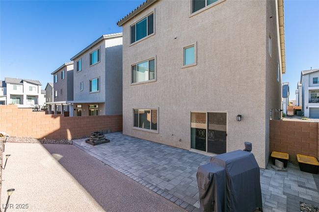Back of property featuring a residential view, stucco siding, fence, and a patio area | Image 36