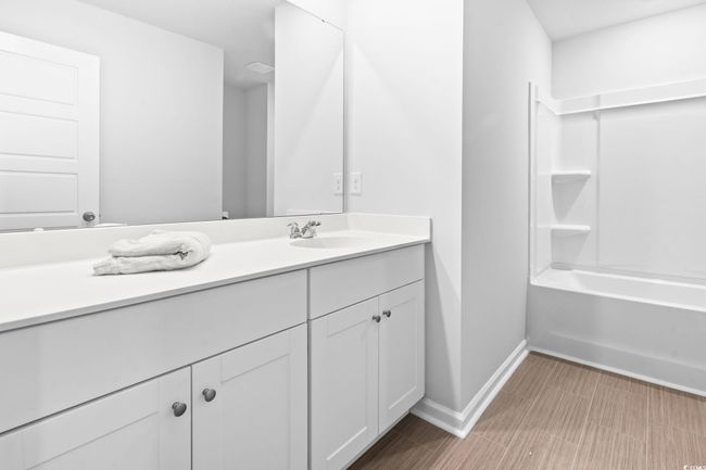 Bathroom with vanity and tub / shower combination | Image 15