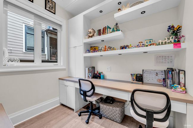 Office with baseboards, light wood finished floors, and built in desk | Image 12