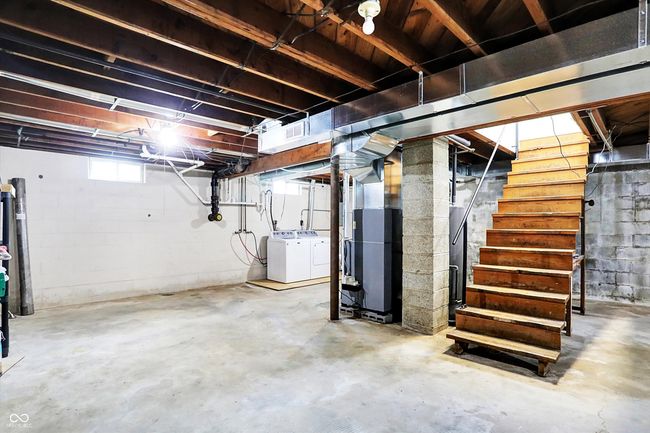 below grade area featuring washing machine and clothes dryer and stairs | Image 20
