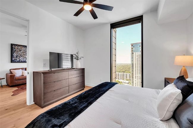 Bedroom featuring light wood-style flooring, access to outside, and a ceiling fan | Image 11