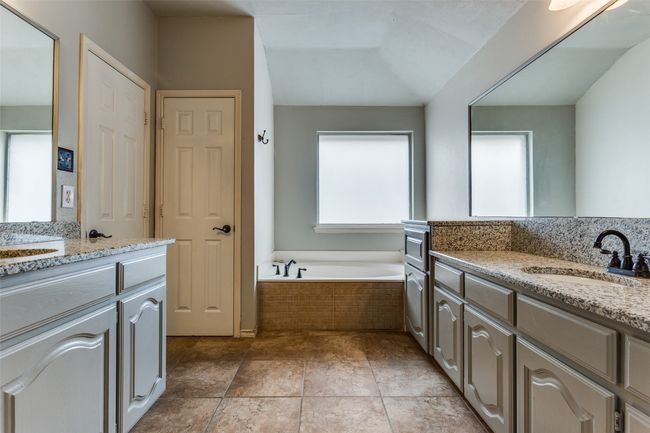 Bathroom featuring a sink, a garden tub, two vanities, and tile patterned flooring | Image 16