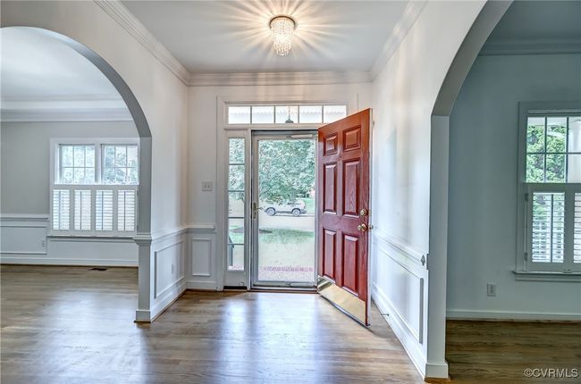 Entry into foyer with archway detail into living & dining room spaces. | Image 5