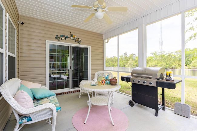 Sunroom / solarium featuring ceiling fan | Image 25