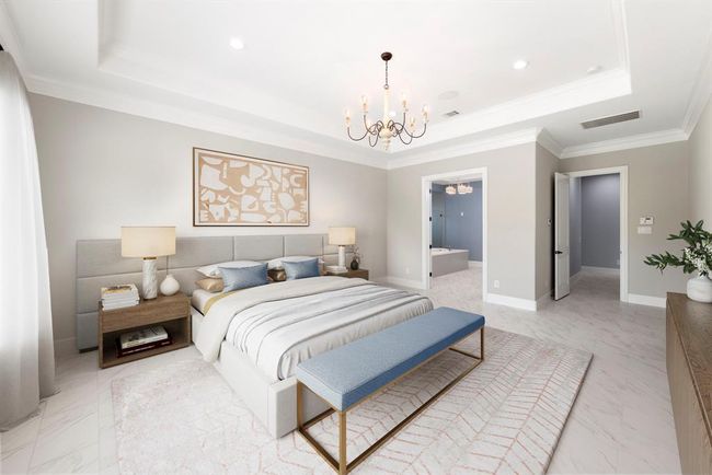 Elegant and airy, the primary suite opens gracefully to a spa-like bath, with soft neutrals, crown molding, and a statement chandelier creating a timeless sanctuary for rest and retreat. *This photo has been virtually staged.* | Image 21